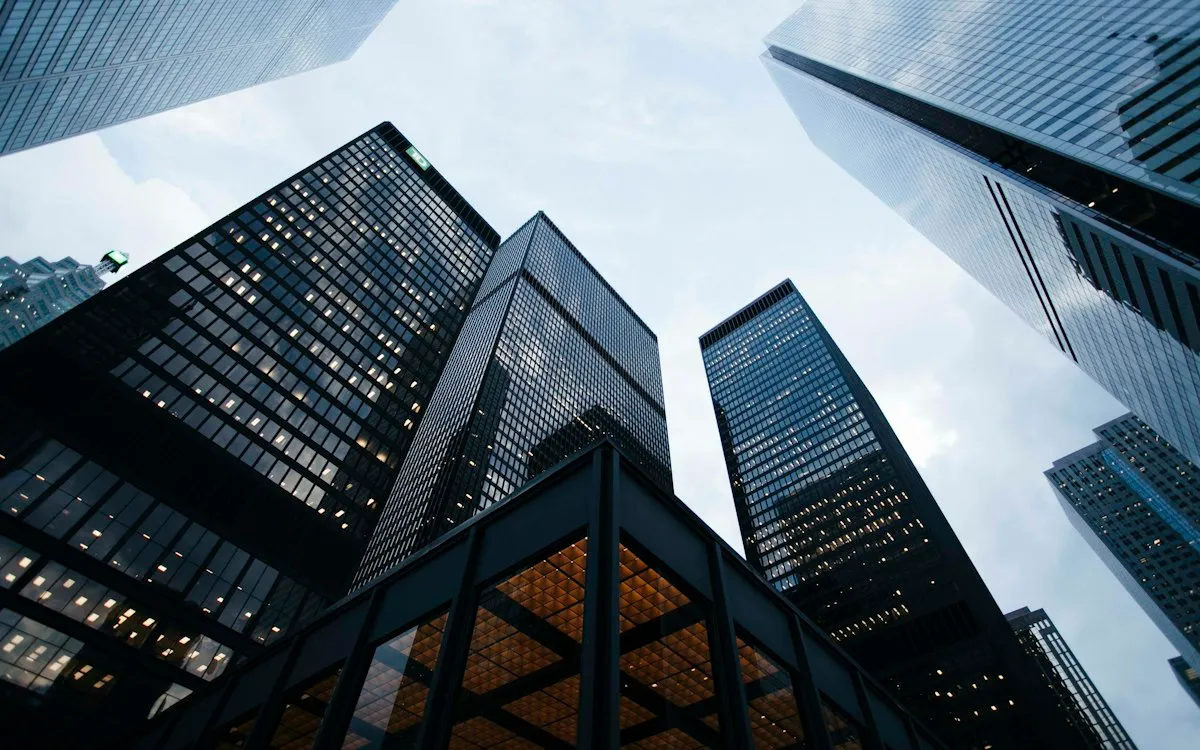 Glass office towers seen from street level.